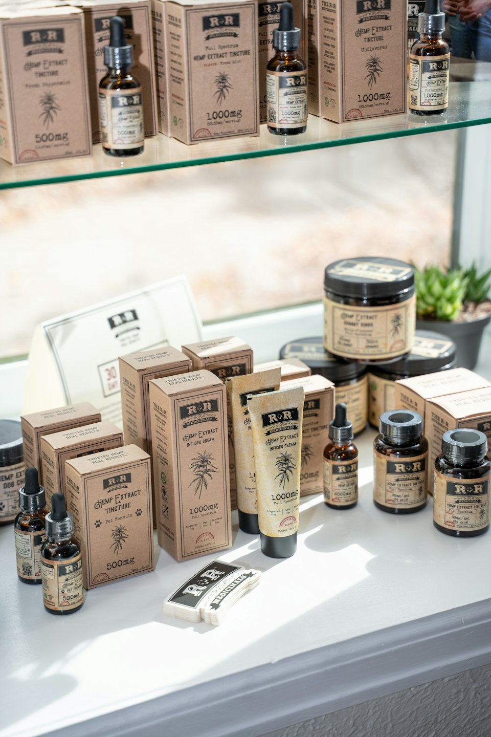 R+R Medicinals hemp extract products displayed on a windowsill.
