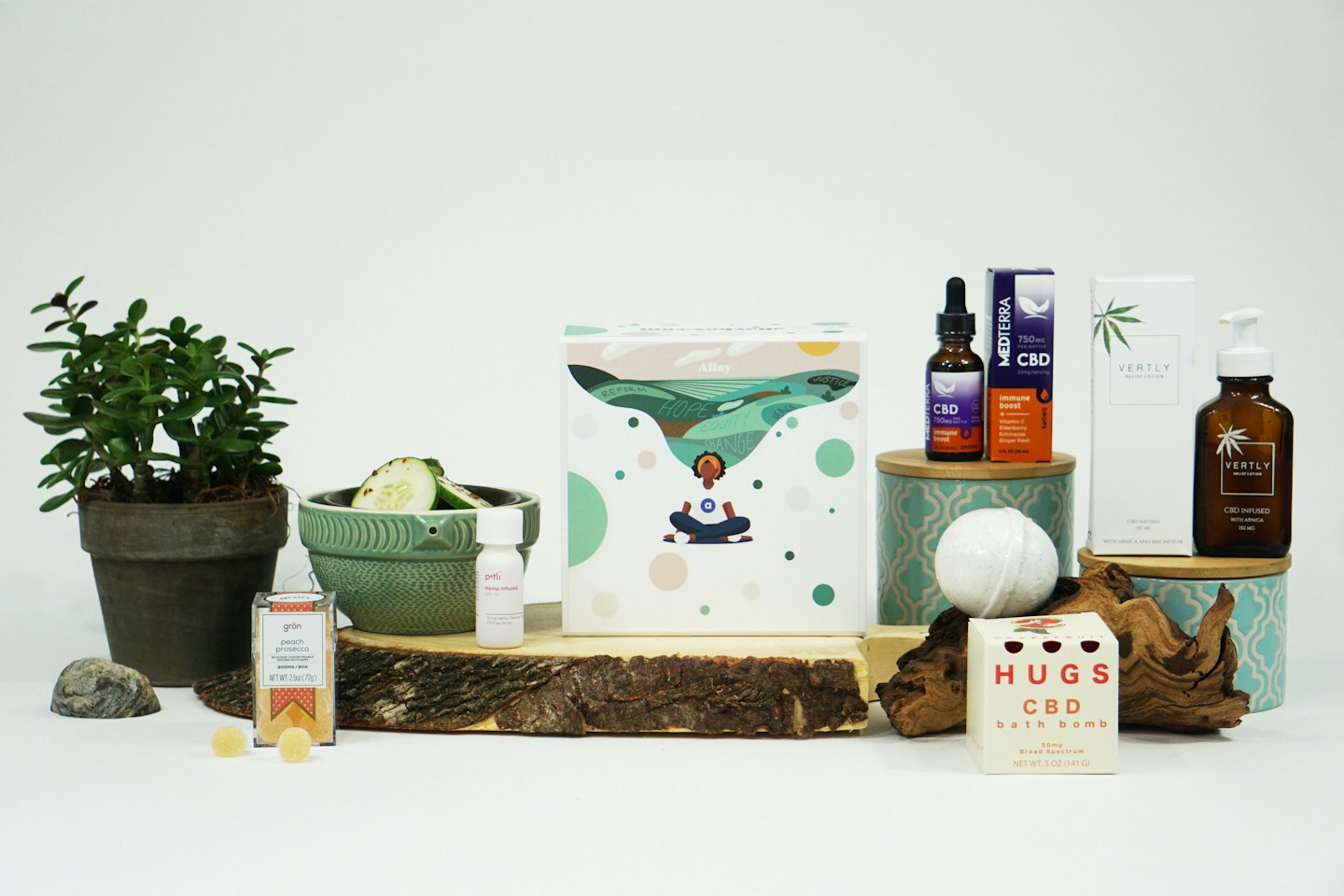 CBD oils and wellness products arranged on wooden planks.